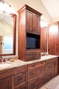 Custom master bathroom cabinets with a space for a small TV.