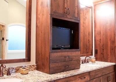 Custom master bathroom cabinets with a space for a small TV.