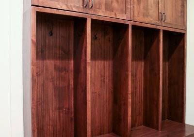 Built-in wooden lockers/cubbies in a mudroom/entryway.