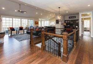 Interior photo of an open-concept living room with stairs leading down to a basement.