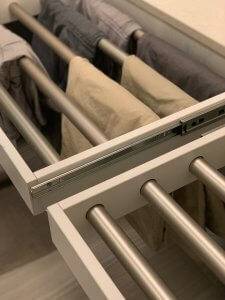 A closeup look at concealed custom laundry drying racks in a laundry room.