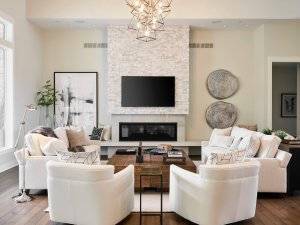 Great room with stone fireplace, built in benches, hardwood flooring and neutral tones.