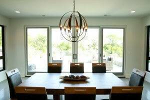 Dining room with double sliding door to backyard patio and lighting fixture