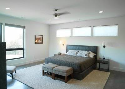 Master bedroom on polished concrete floors with modern design styles.
