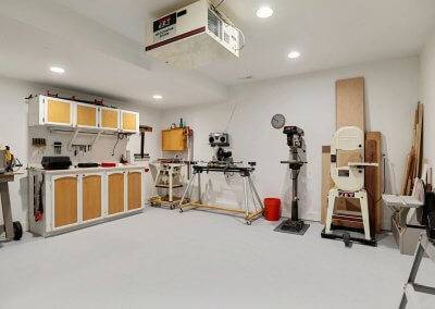 Work shop with air purifier, finished floor and table saws, tools, etc.