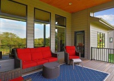 Covered patio with red deck furniture.