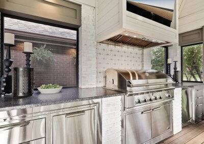 Outdoor kitchen counter for grill, refrigerated drawers, exhaust hood and screens.