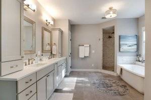 Master bathroom with walk in tiled shower, soaking tub, dual vanity and tiled floor.