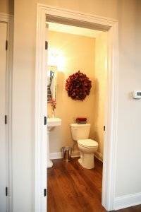 Spare bathroom with hardwood flooring.