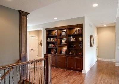 Custom built-in shelving unit and display with recessed lighting.