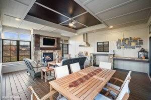 Three season screened patio with grill, fireplace and dining area.