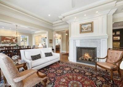 Great room with marble fireplace and crown molding.