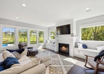 Great room with bench seating, fireplace and view to the pool