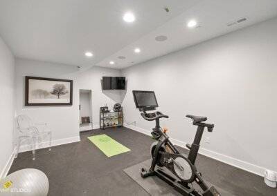Exercise room with mounted television.