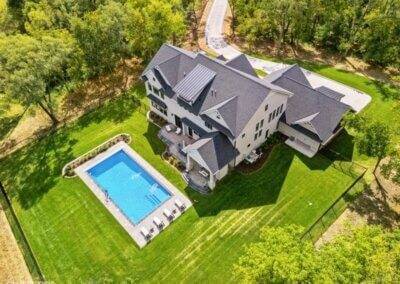 Aerial photo of custom two story home with pool.